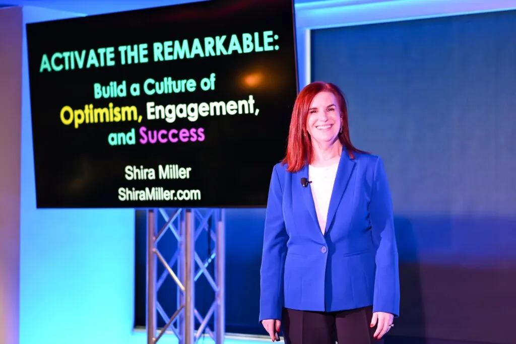 Keynote speaker presenting on stage in the Dallas event space